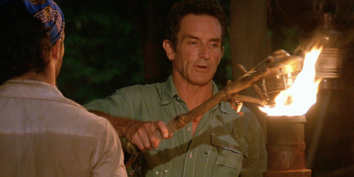 Jeff Probst snuffing a torch at tribal council