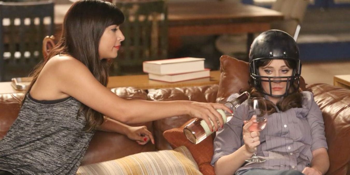 Jess wearing Nick's football helmet and Cece giving her wine