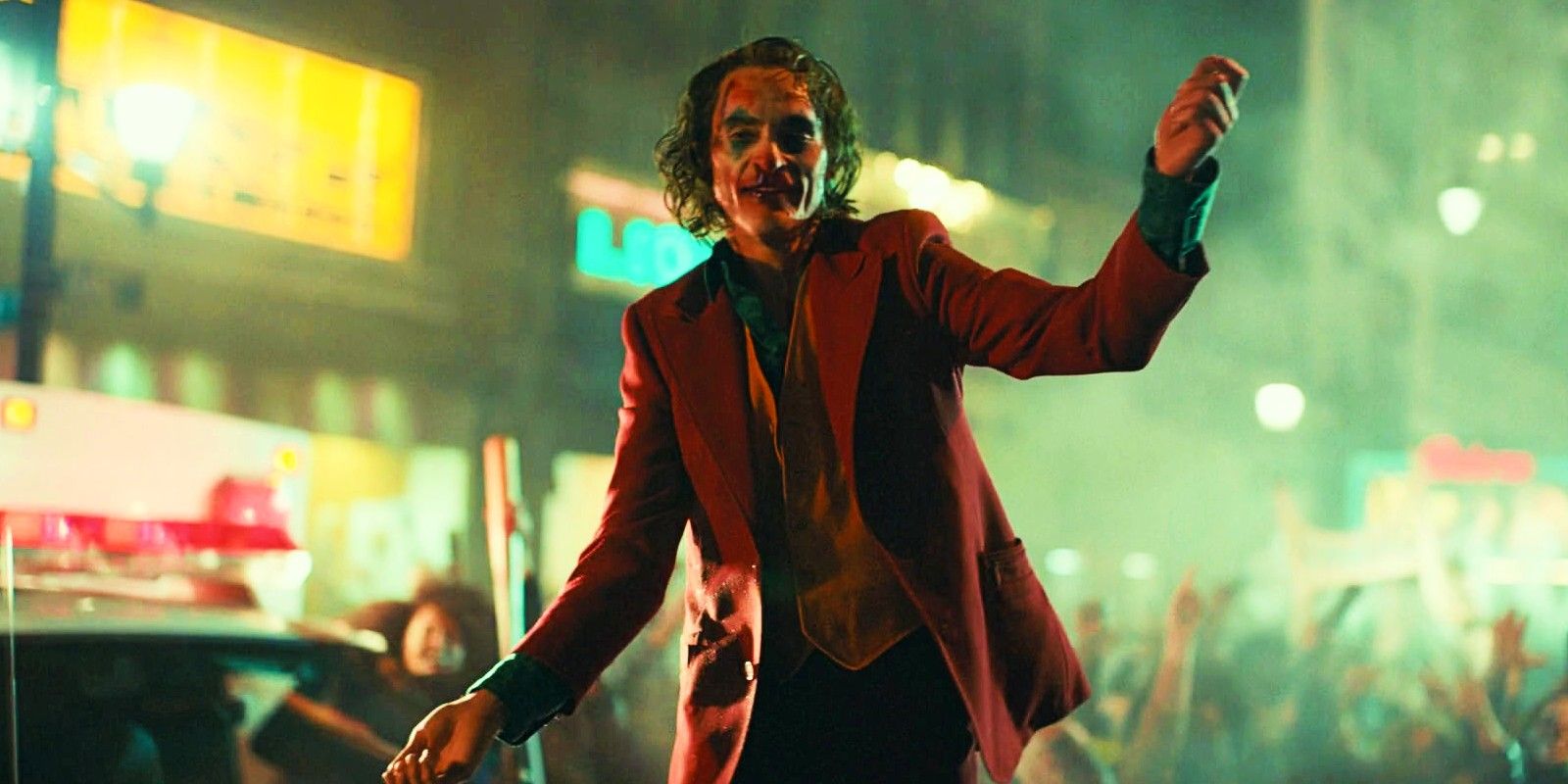 Joker dancing on car during riot in Joker