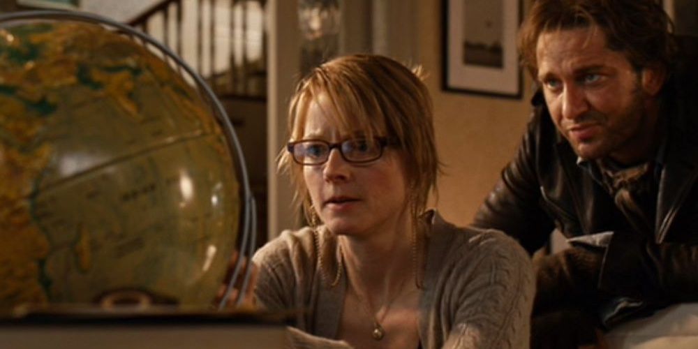 Jodie Foster and Gerard Butler staring at a globe in a still from Nim's Island.