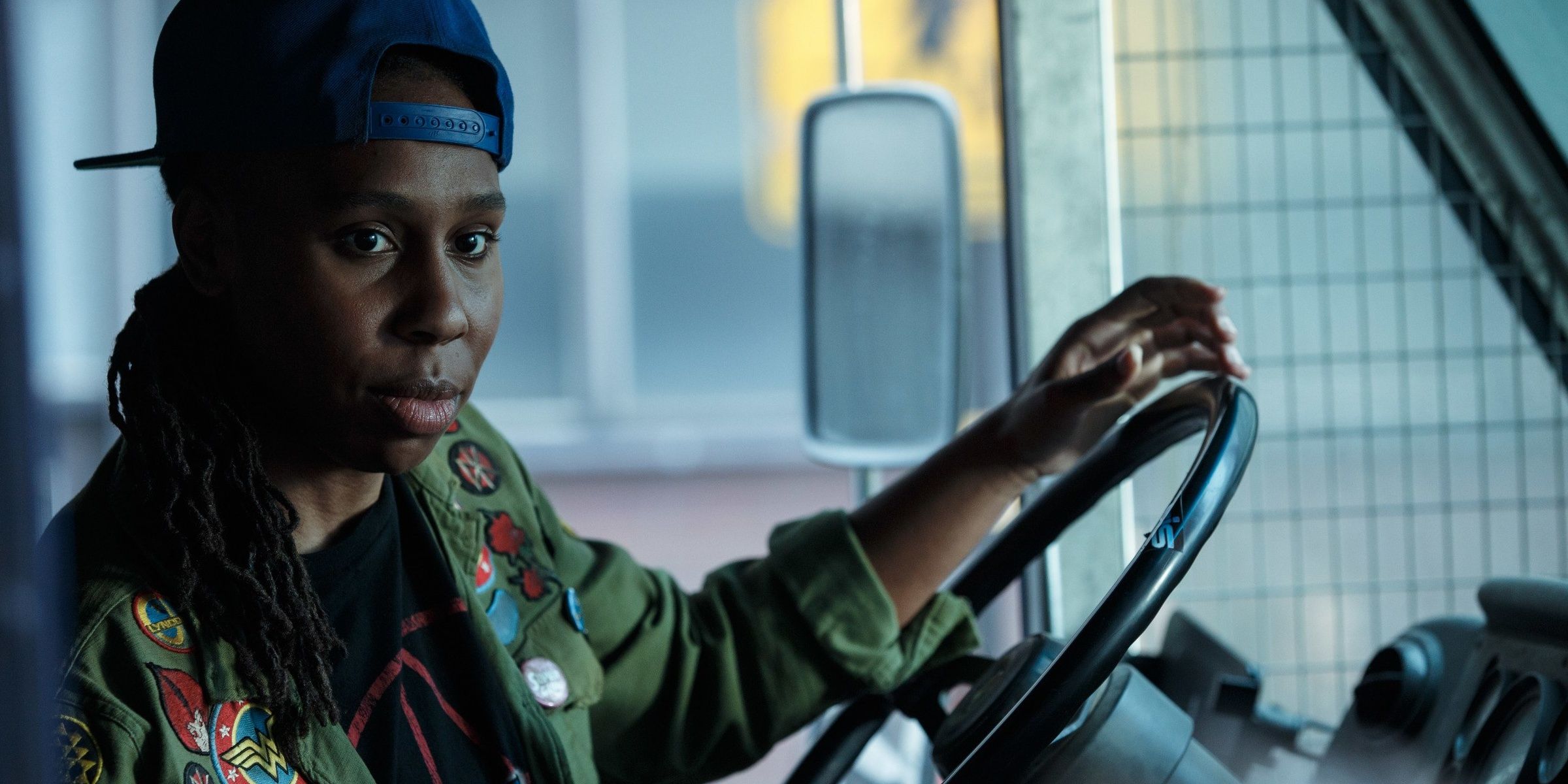 Lena Waithe with her hands on a bus's steering wheel in Ready Player One