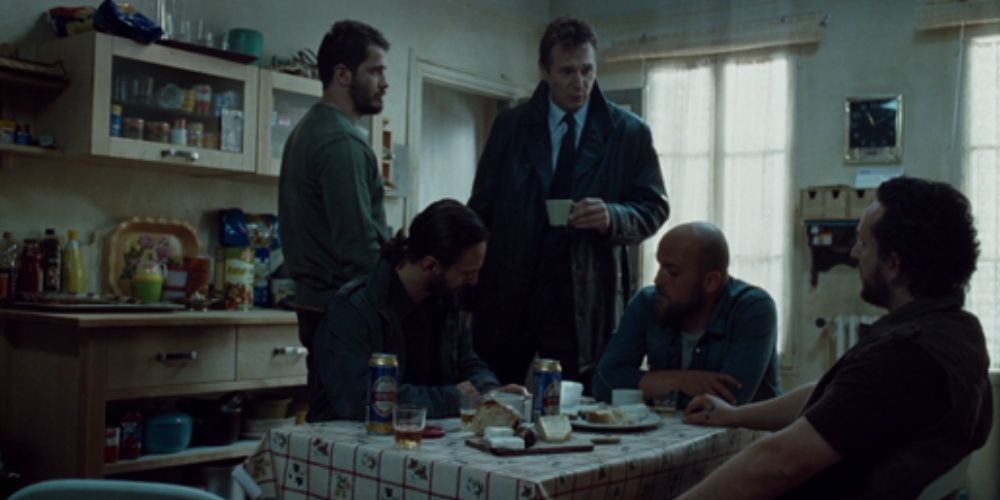 Liam Neeson at an Albanian hideout with a letter in his hand in a still from Taken