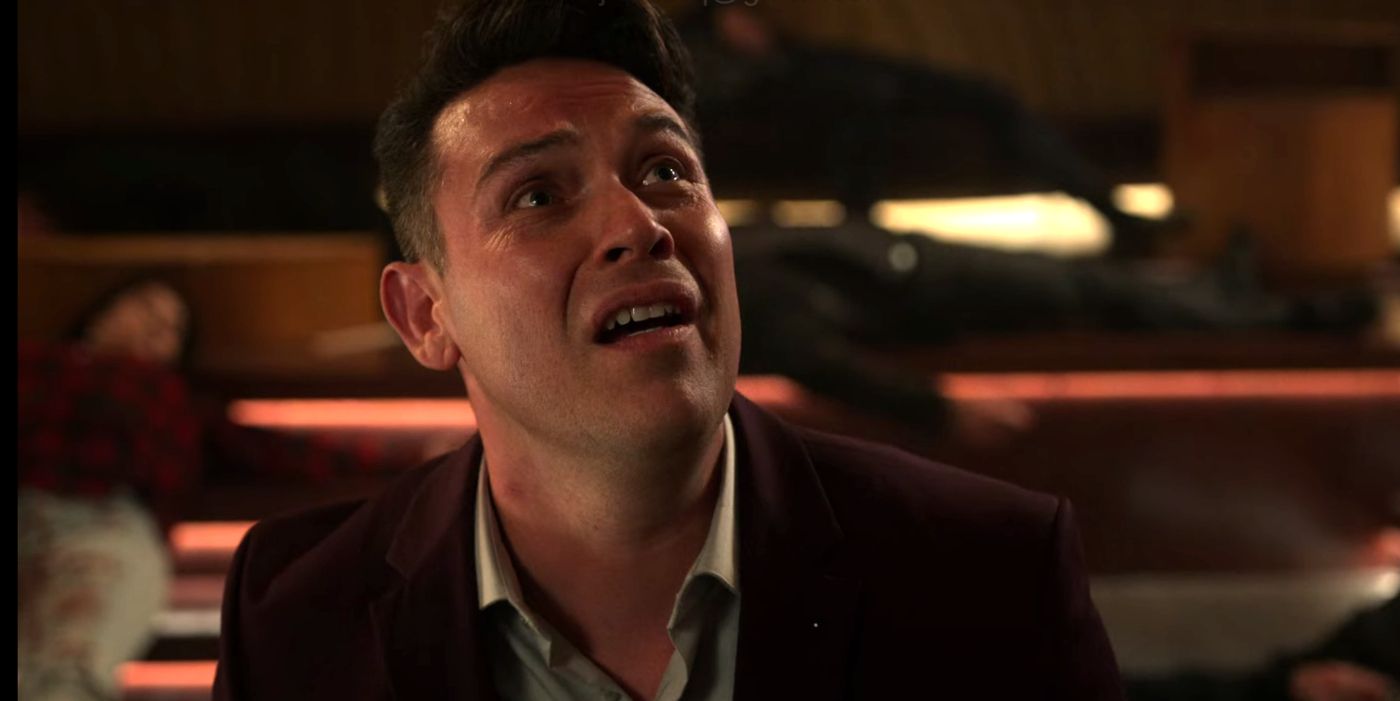 Dan looking up in fear at someone on Lucifer.