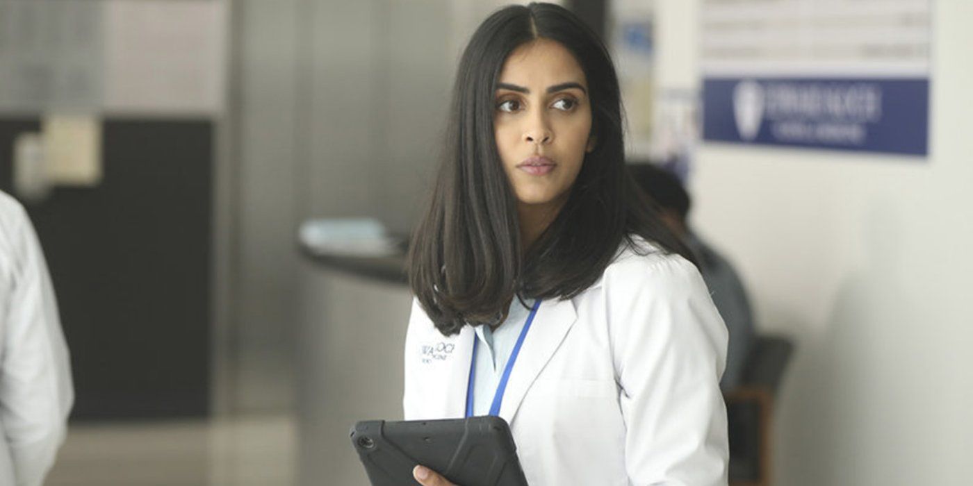 Saanvi wearing her labcoat and ID as she holds a gadget in Manifest.