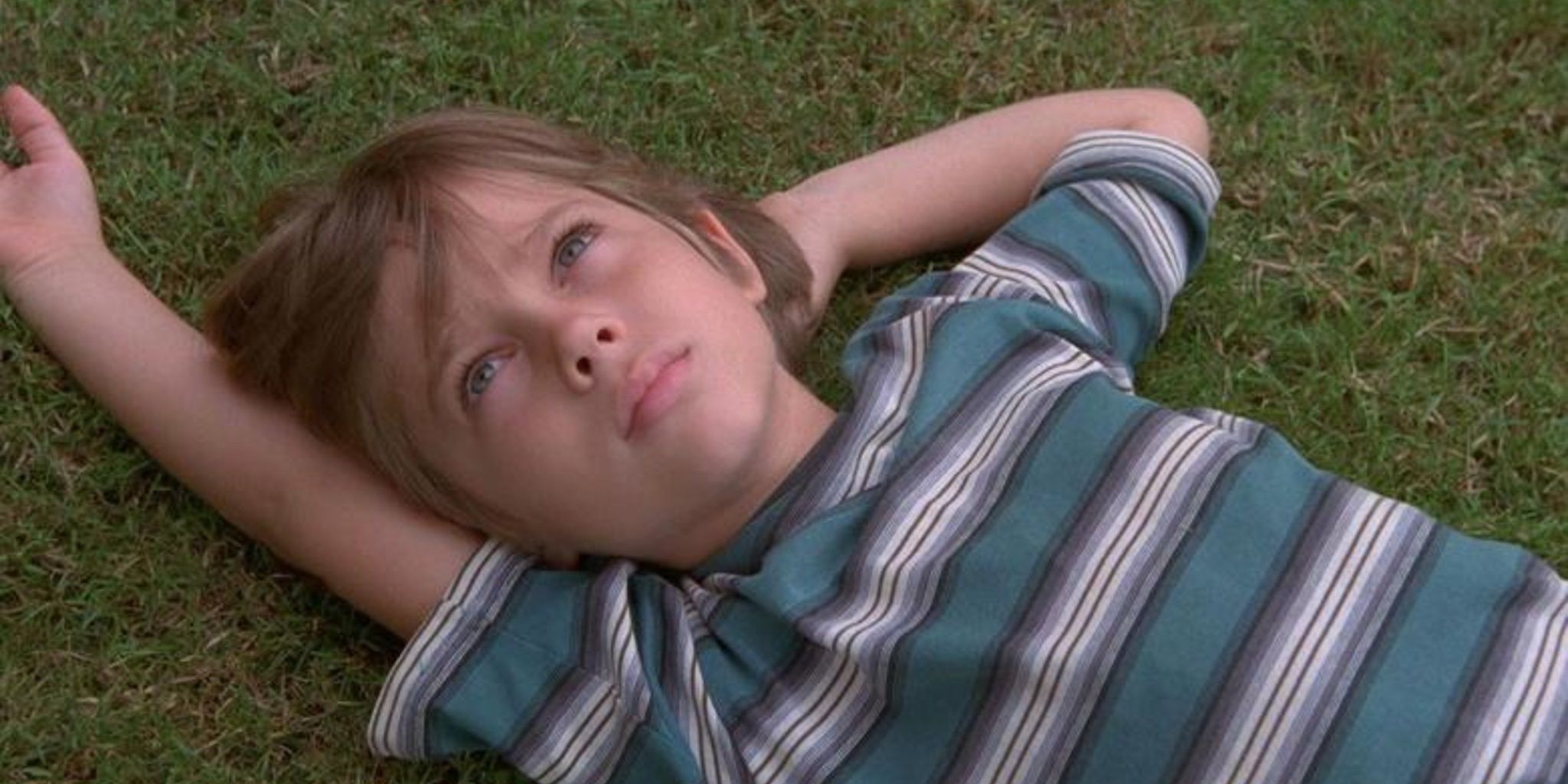 Mason Evans Jr lying in the grass in the opening scene of Boyhood