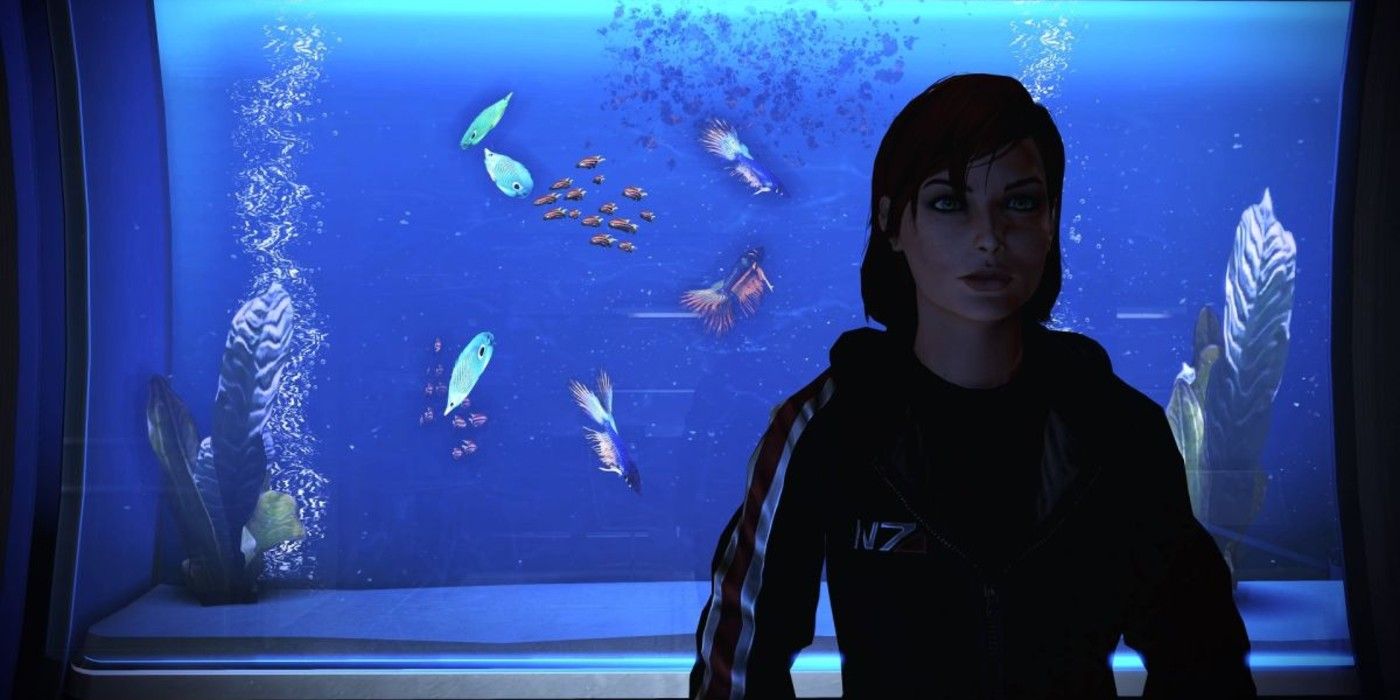 Shepard stands in front of her fish tank in her cabin in Mass Effect 2
