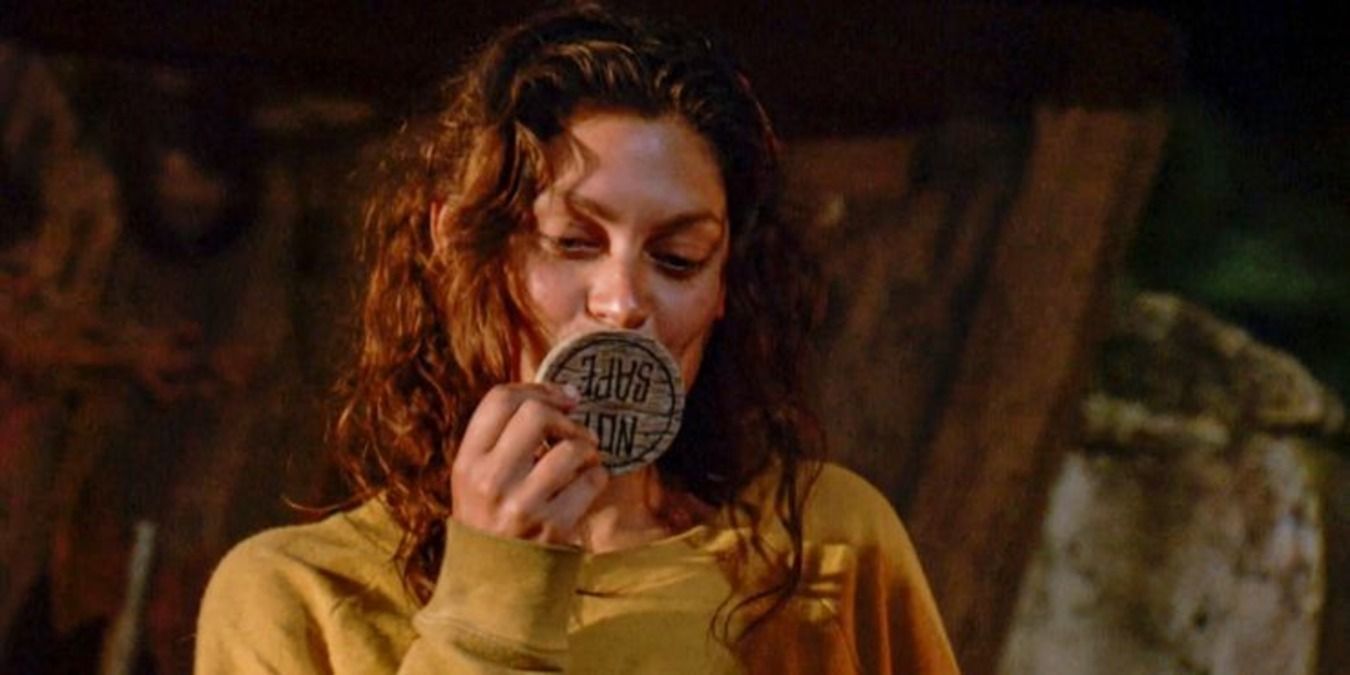 Michele kissing the 50 50 coin at tribal council in Winners at War