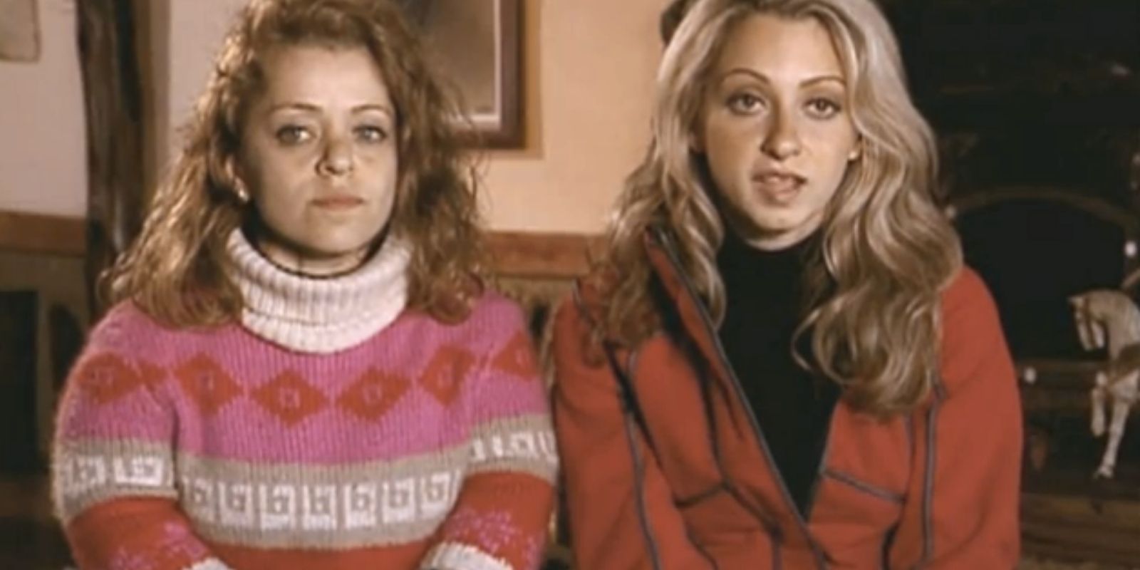 Mirna and Charla in The Amazing Race talking to camera with sweaters on.