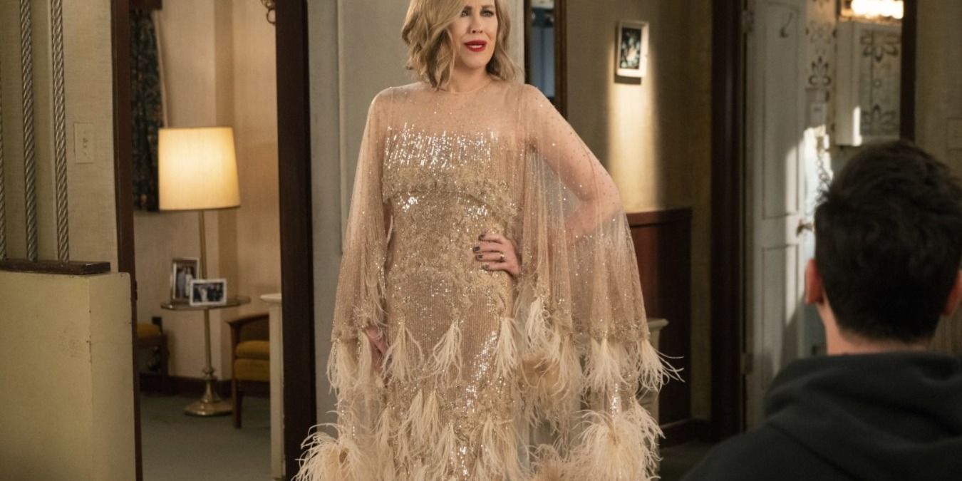 Moira in the motel room wearing her premiere dress