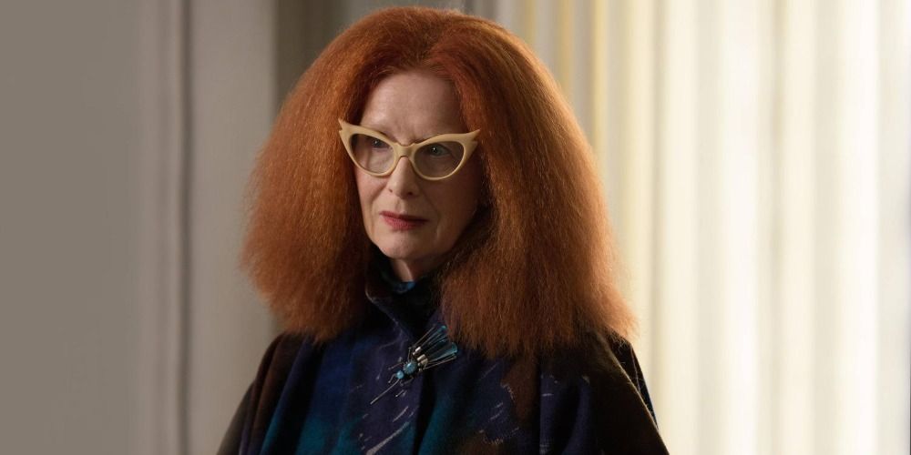 Myrtle Snow standing in the academy in a scene from Coven
