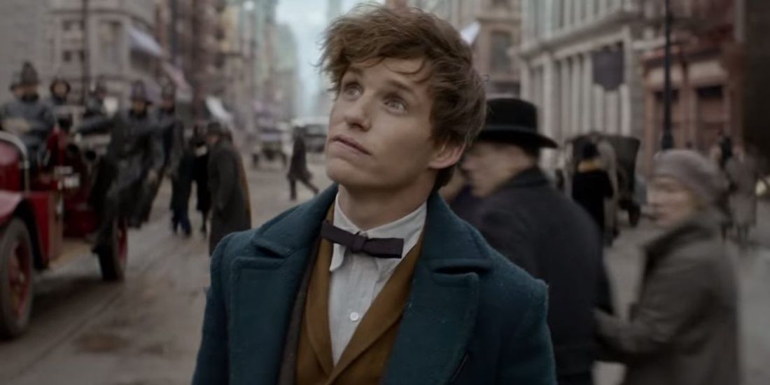 Newt Scamander looking up to his right with suit and bowtie on in Fantastic Beasts &amp; Where to Find Them