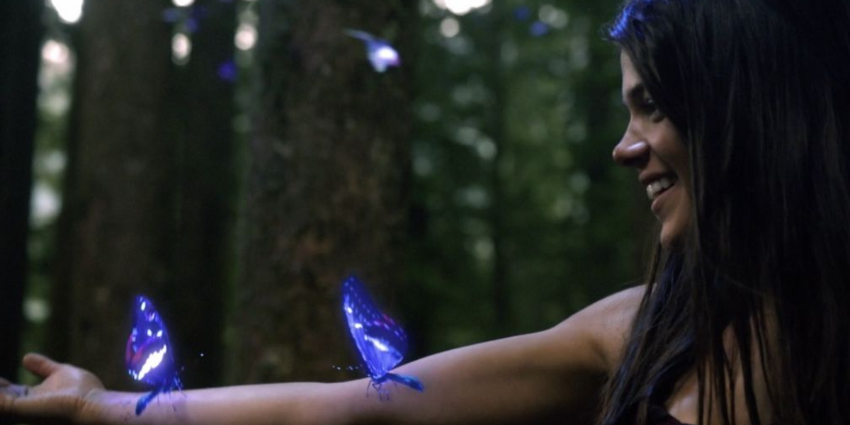 Octavia with radioactive butterflies on her arm in The 100