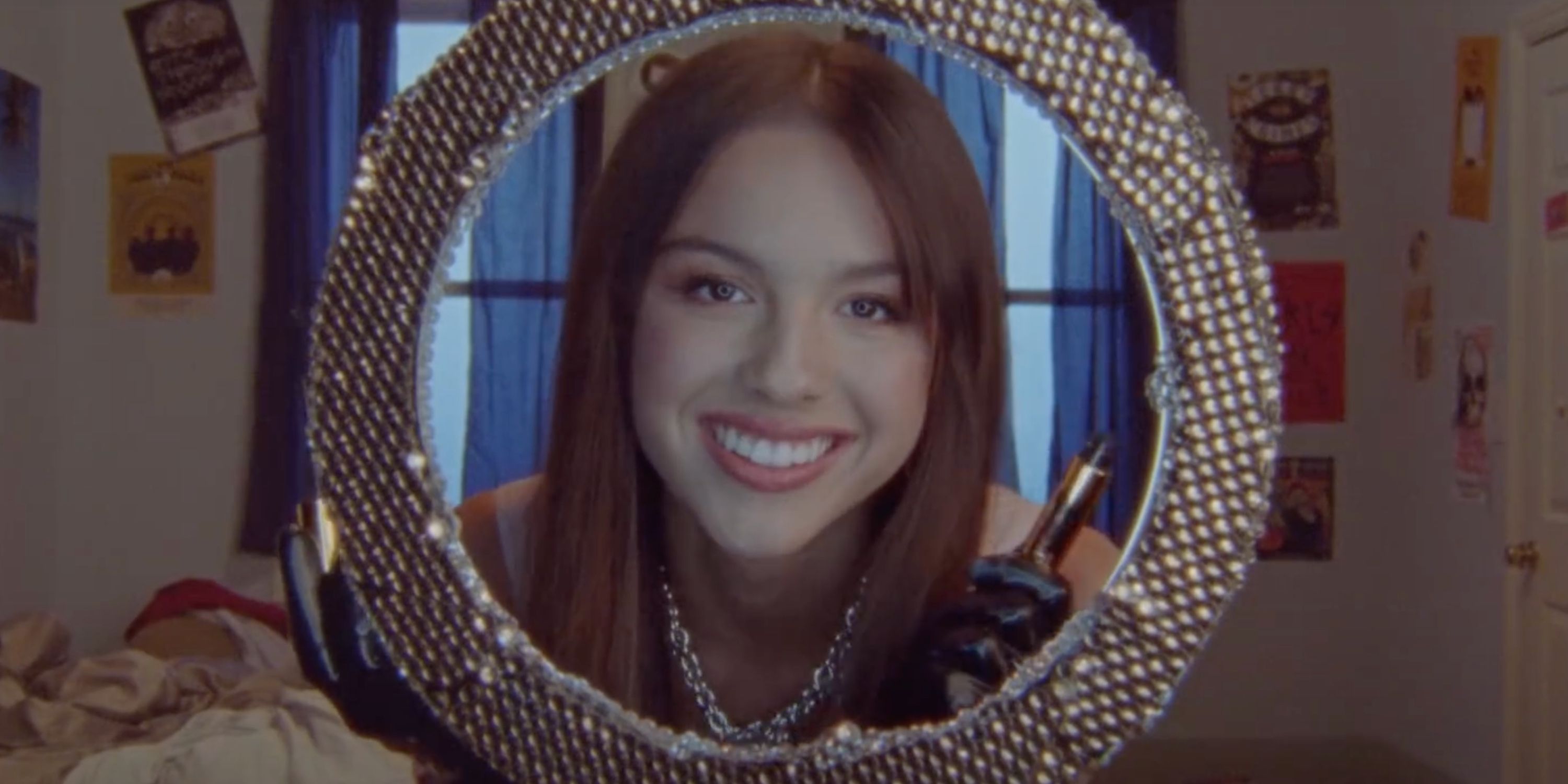 Olivia Rodrigo looking at herself in the mirror in a still from Good 4 U's music video
