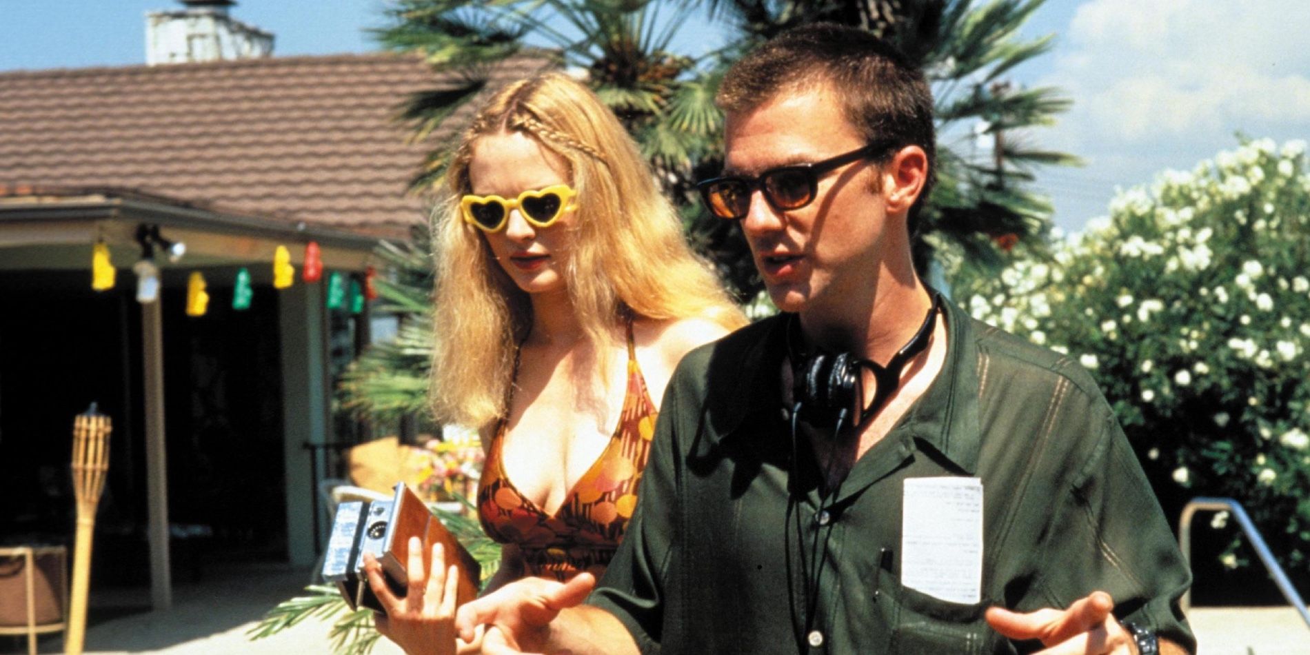 Paul Thomas Anderson directing Boogie Nights with Heather Graham behind him