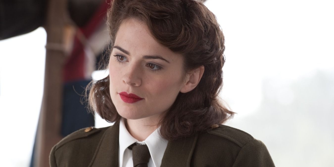 Peggy Carter in uniform, standing by a window