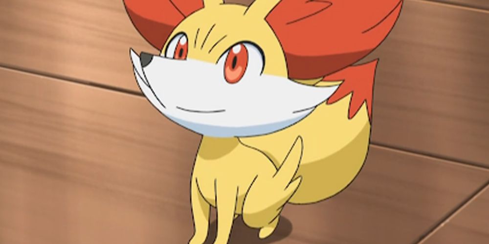 Fennekin smiling and looking up in the Pokémon anime