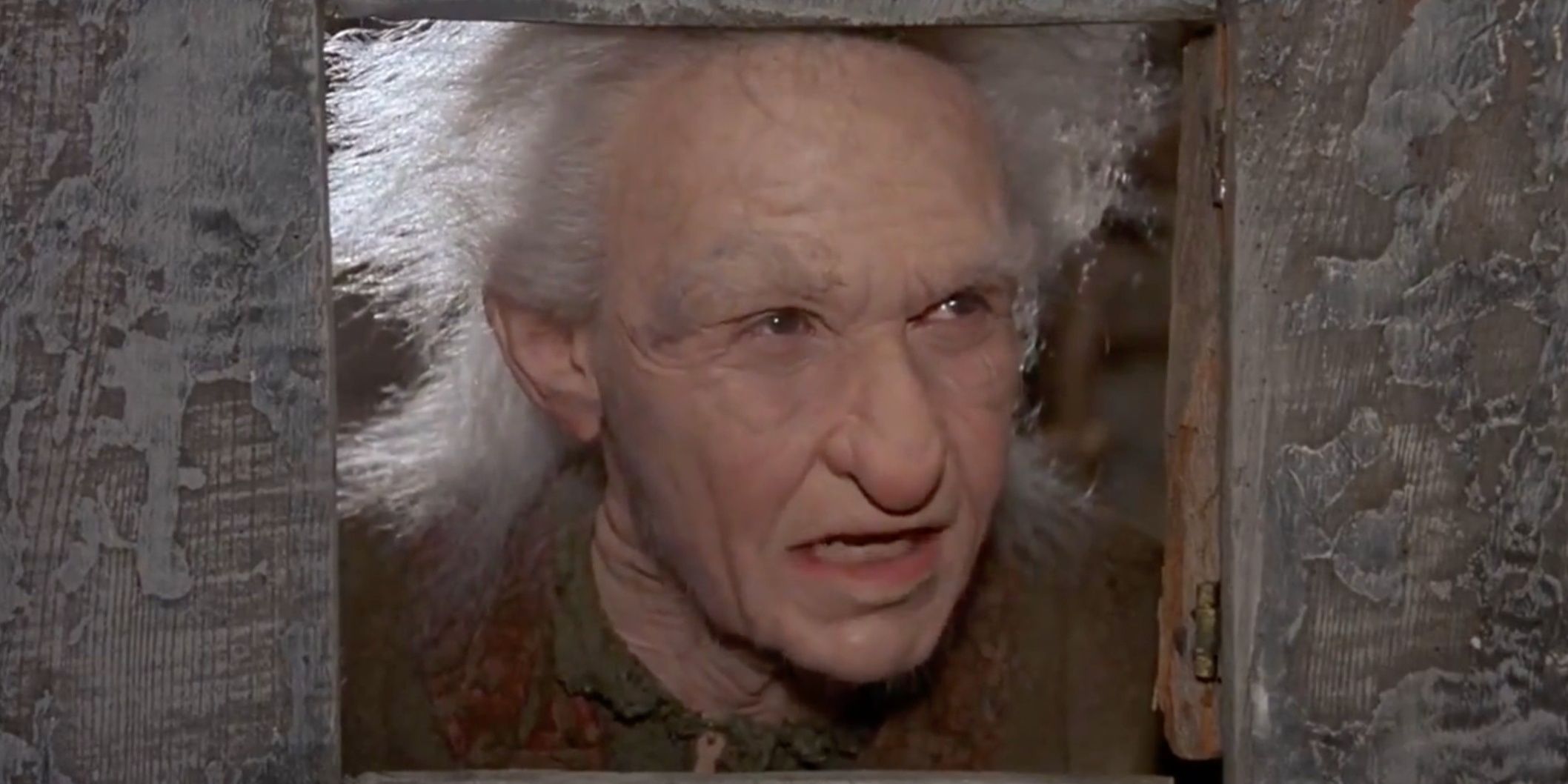 Miracle Max (Billy Crystal) looks through hole in The Princess Bride