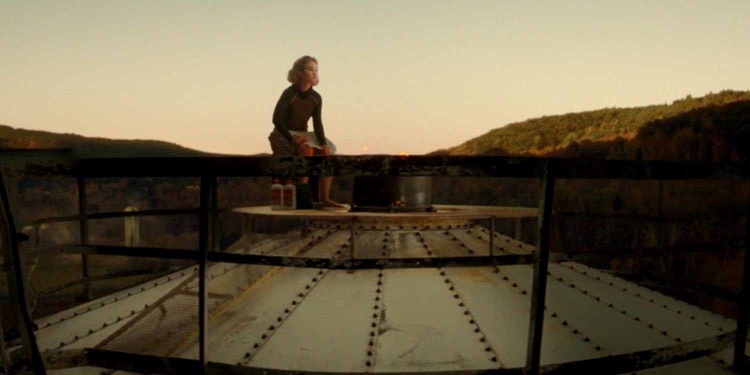 Regan Abbott sitting on the silo in A Quiet Place Part II