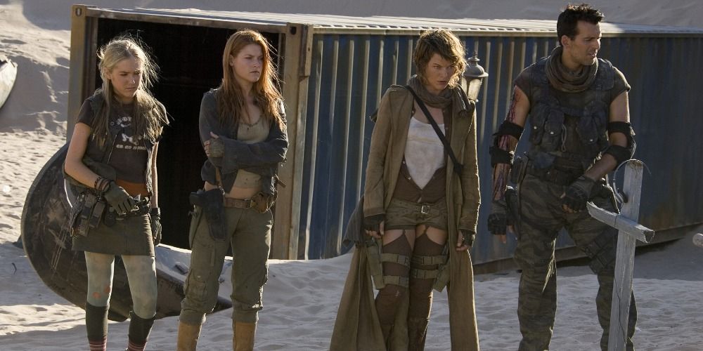 K-Mart, Claire, Alice and Carlos holding weapons and standing together in a scene from Resident Evil Extinction
