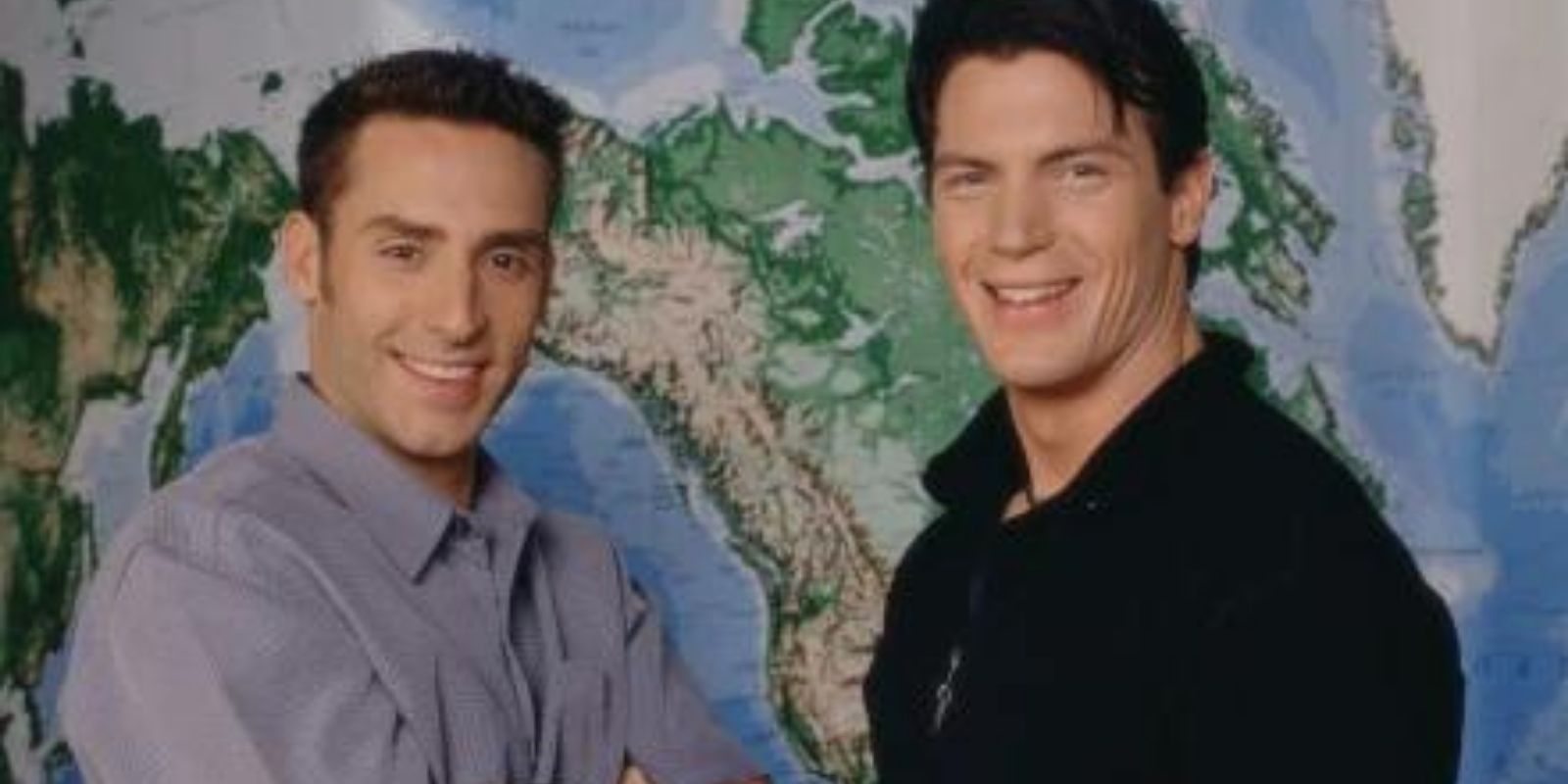Rob &amp; Brennan from The Amazing Race standing side by side in front of a world map.