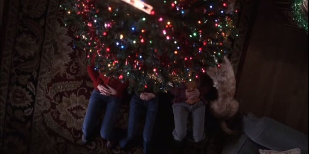 A group of people beneath a Christmas tree.