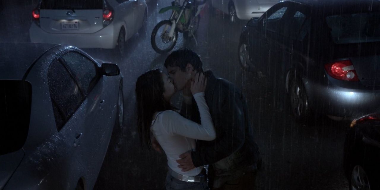 Scott and Kira kiss in the rain.
