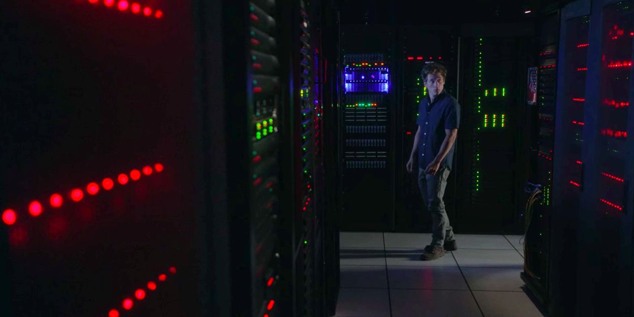 Lip from Shameless Walks through a control room at night.