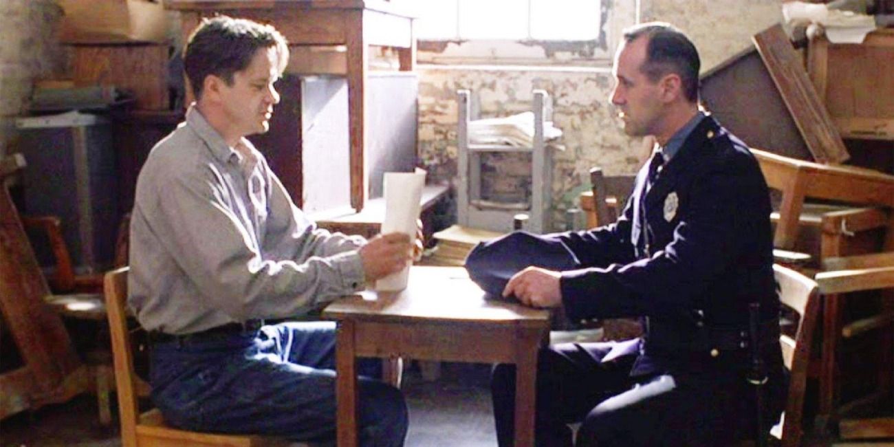 Shawshank Redemption Andy and guard sit at a table doing paperwork