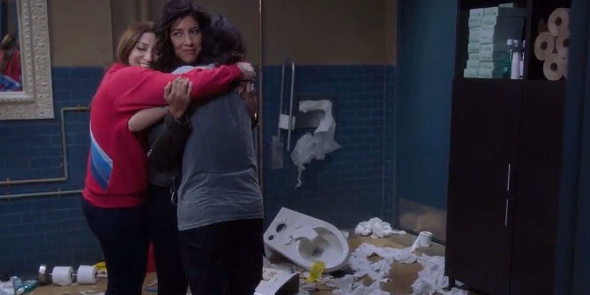 Gina and Amy hugging Rosa.