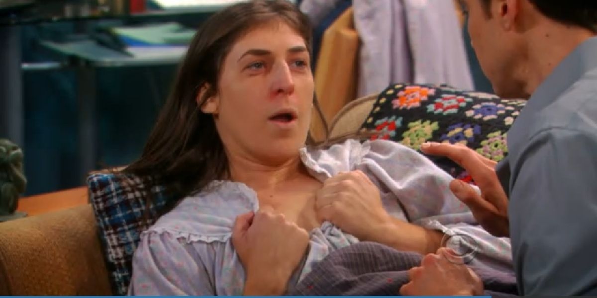 Sheldon rubs Vicks on Amy's chest