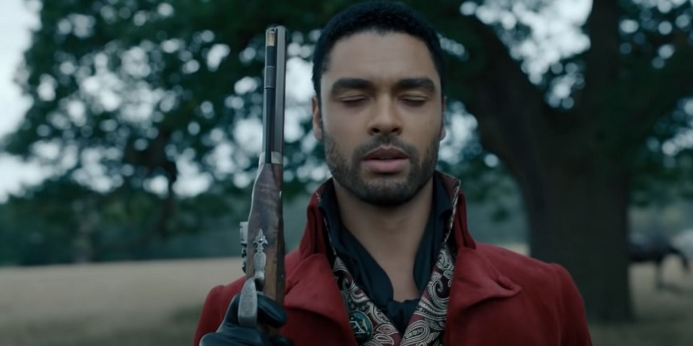 Simon at the duel, holding his gun up with his eyes closed