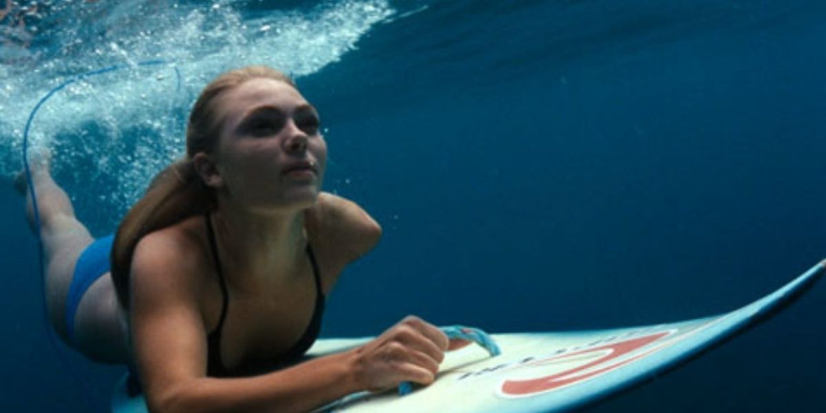 Anna Sophia Rob as Bethany in the ocean on a surf board