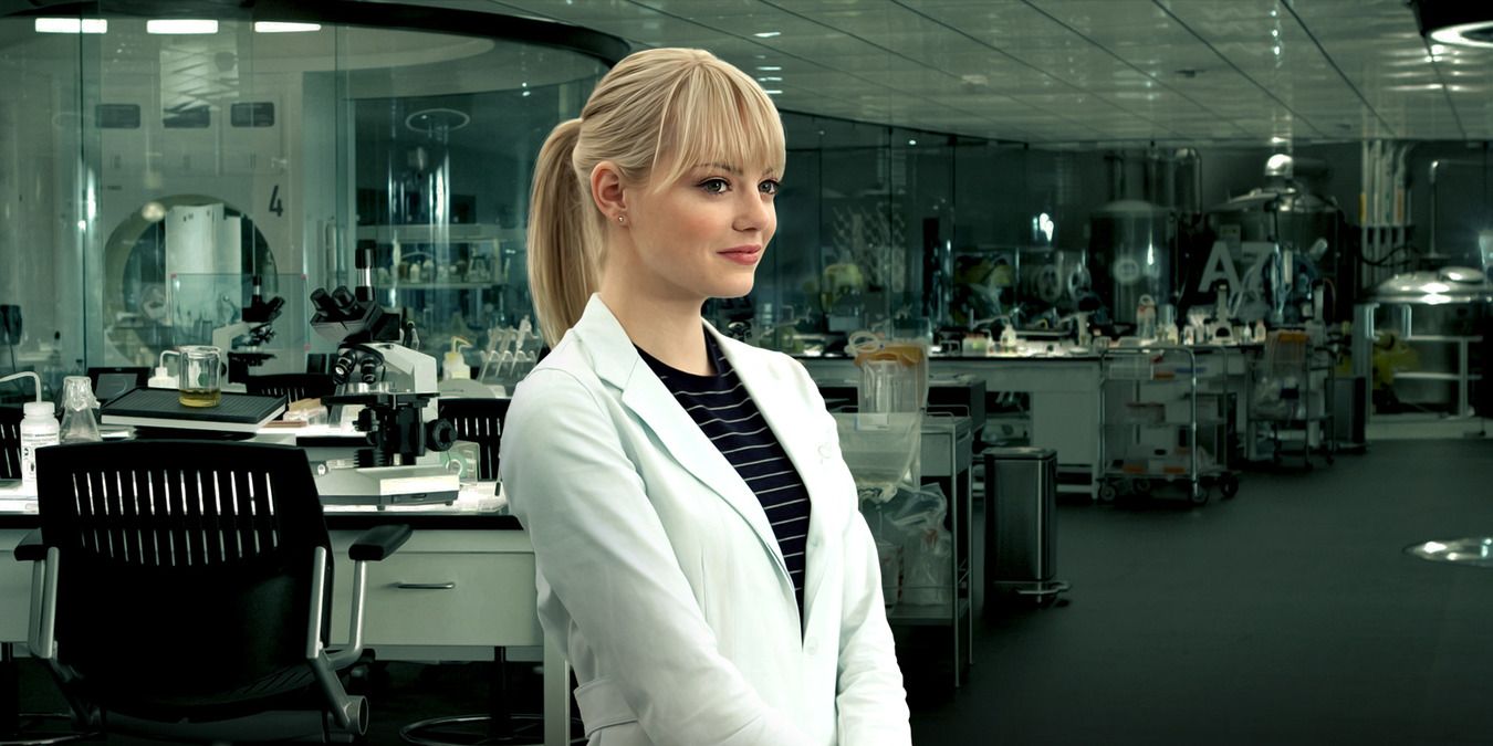 The Amazing Spider-Man's Gwen Stacy standing in a lab coat in the lab at Oscorp