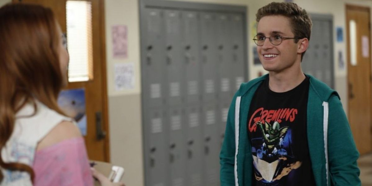 Adam wearing a Gremlin's shirt in the hallways