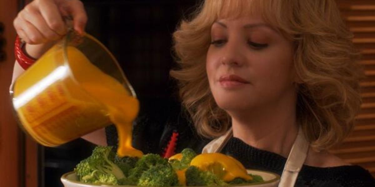 Beverly pouring melted cheese on broccoli 