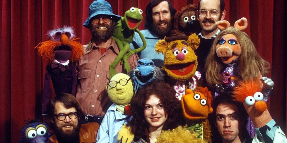 Group of Muppets from the Muppet show with Jim Henson and other puppeteers.