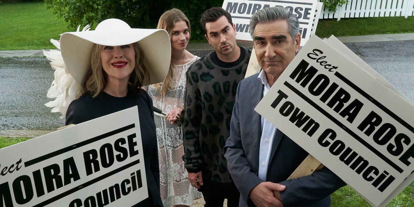 The Rose family holding Moira's campaign signs