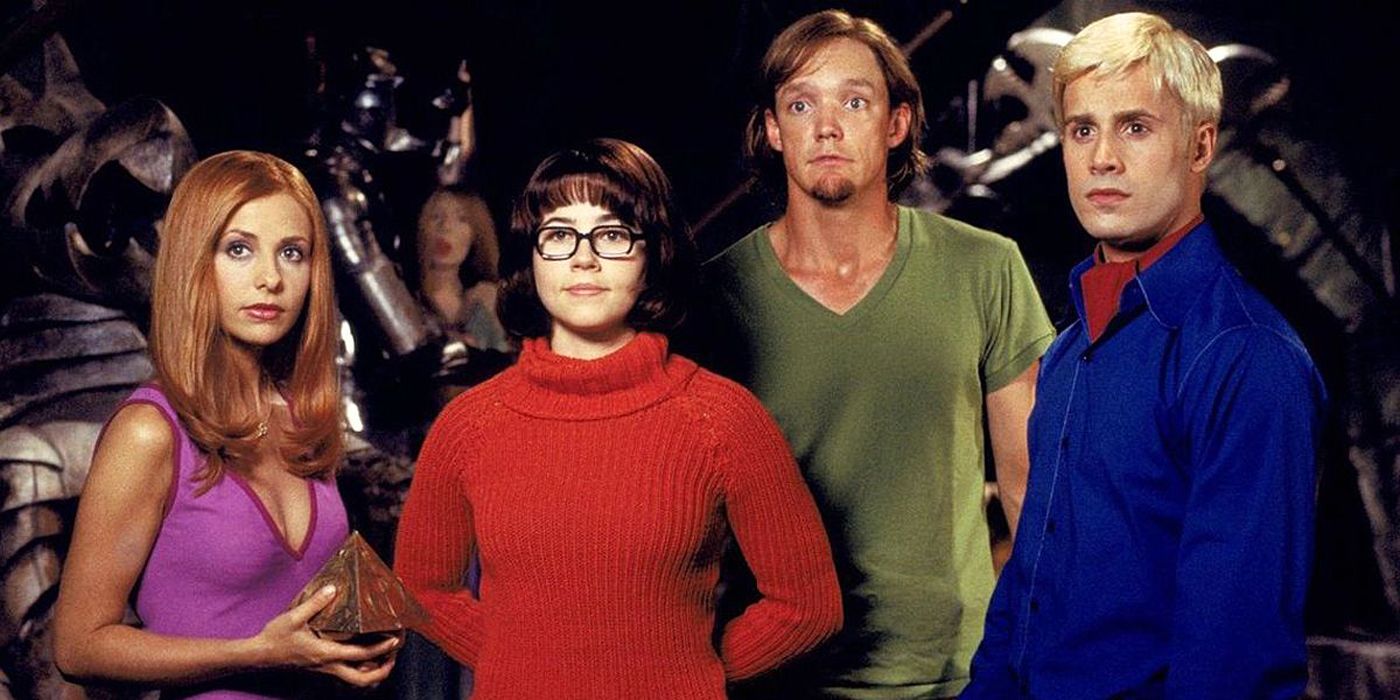 The Scooby Doo gang: Daphne, Velma, Shaggy and Fred standing together.