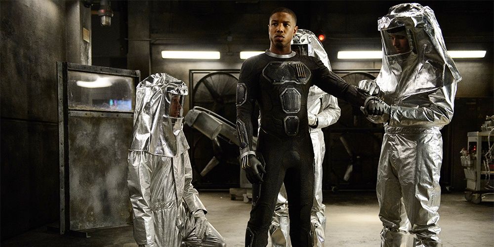 The Torch surrounded by people in fireproof suits in Fantastic Four 2015