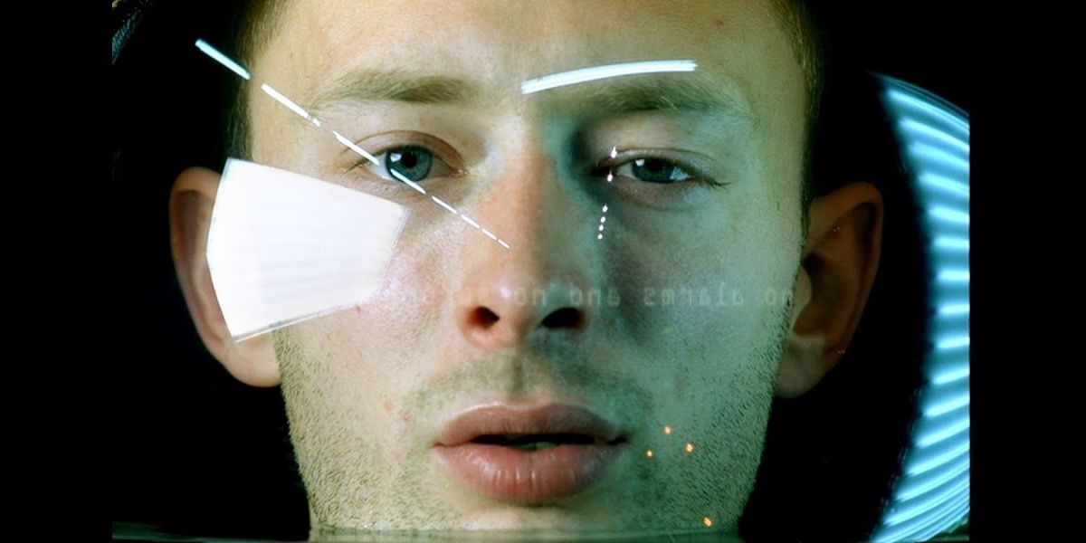 Tom Yorke wearing a diving helmet filled with water in a still from No Surprises.