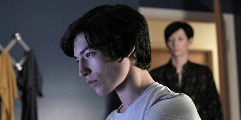 Ezra Miller at computer and Tilda Swington at bedroom door in We Need to Talk About Kevin