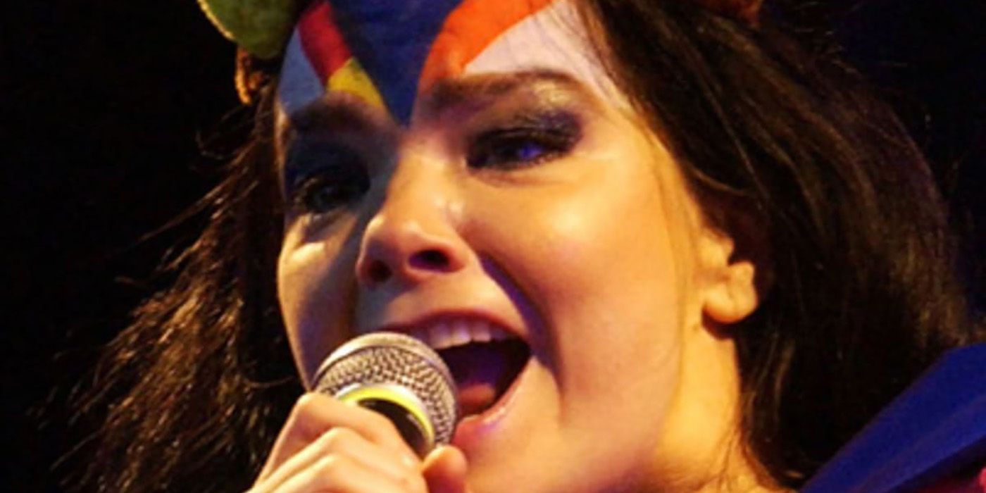 A close up of Bjork singing into a microphone