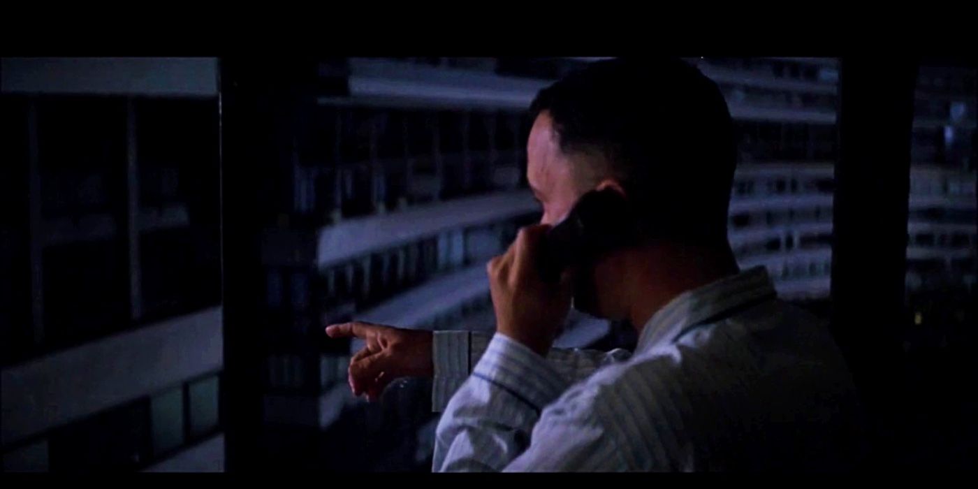Forrest on his phone in the dark and pointing out the window in Forrest Gump