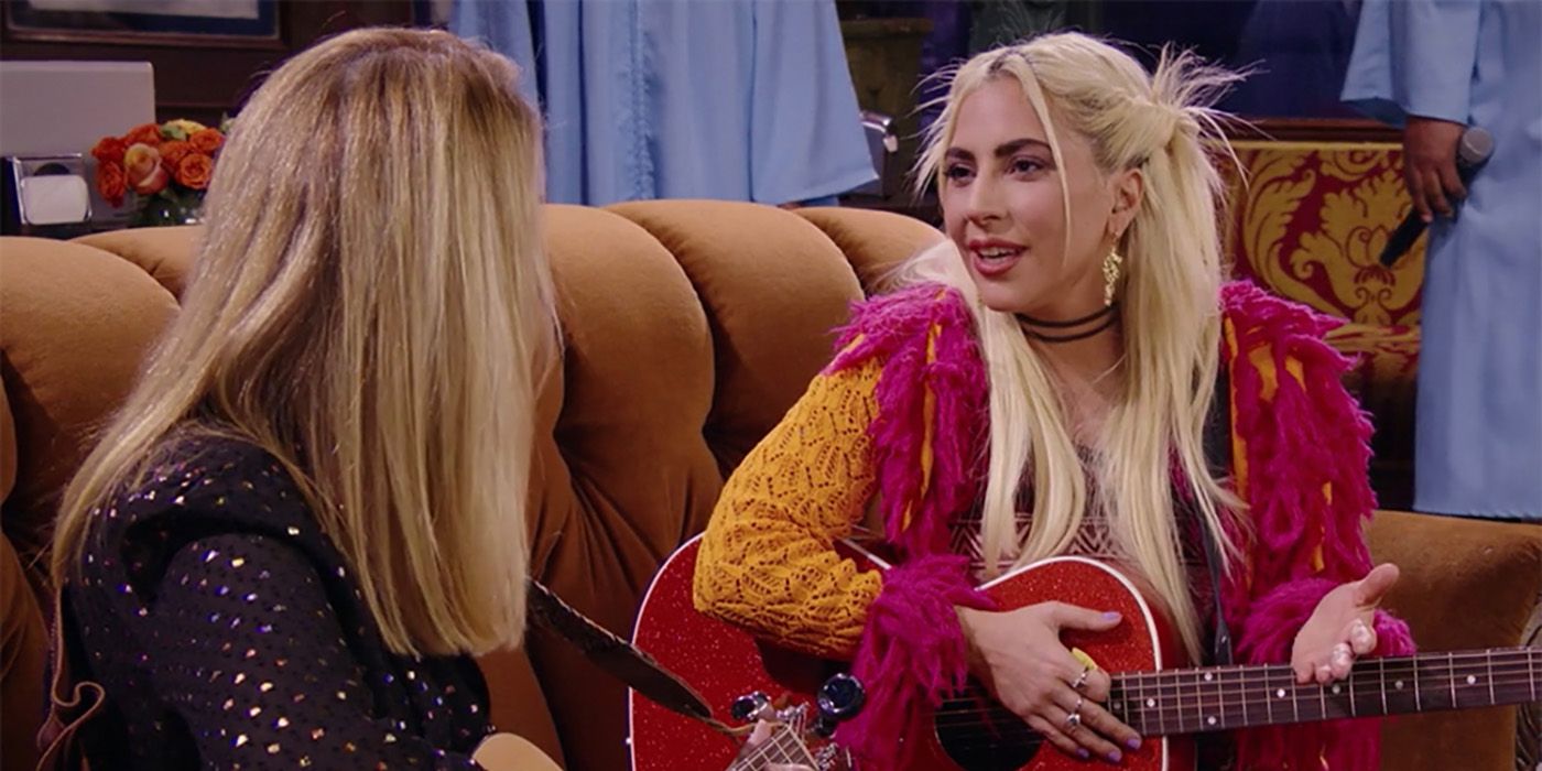 Lady Gaga sits with Lisa Kudrow playing the guitar in Friends: The Reunion