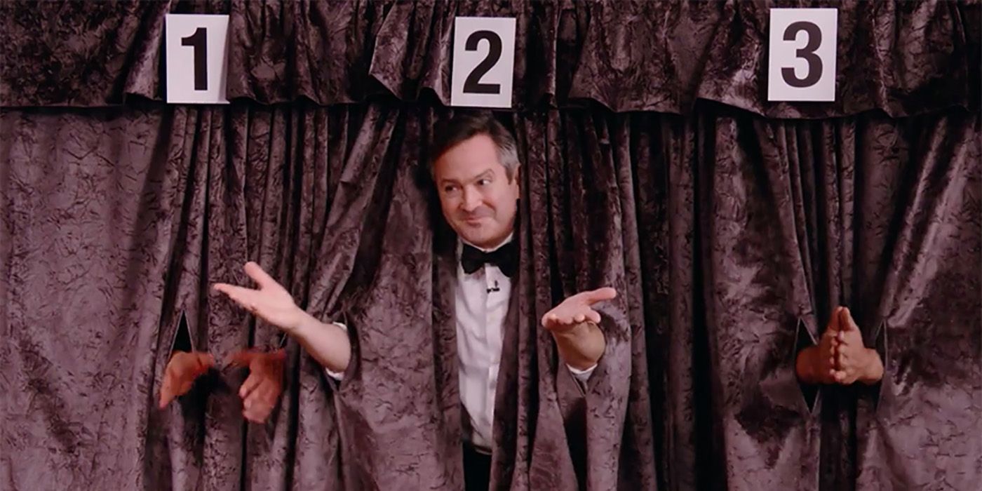 Thomas Lennon poking his head out from behind a curtain on The Friends Reunion