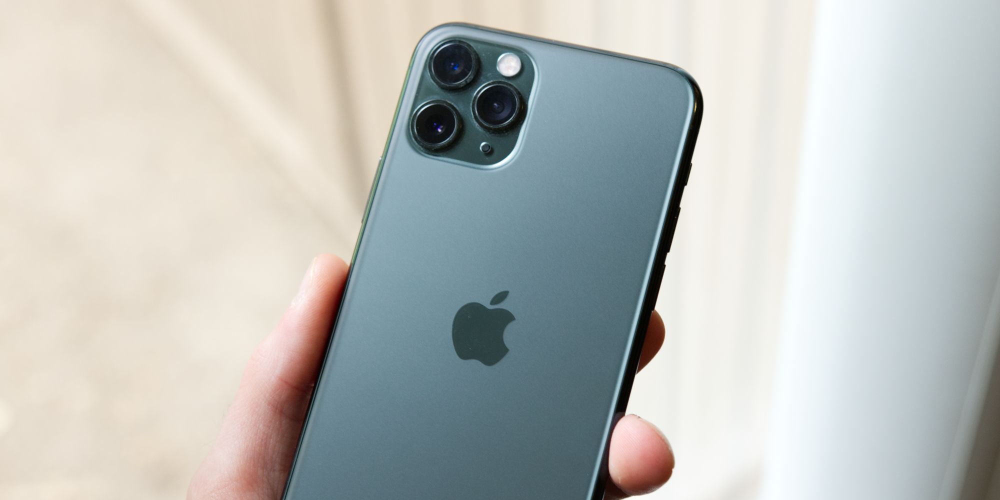 The back of an iPhone 11 Pro in green