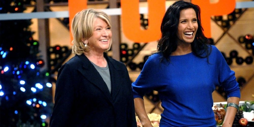 Martha Stewart wearing a black jacket over a grey blouse standing next to Padma Laxmi who is wearing a blue top on Top Chef