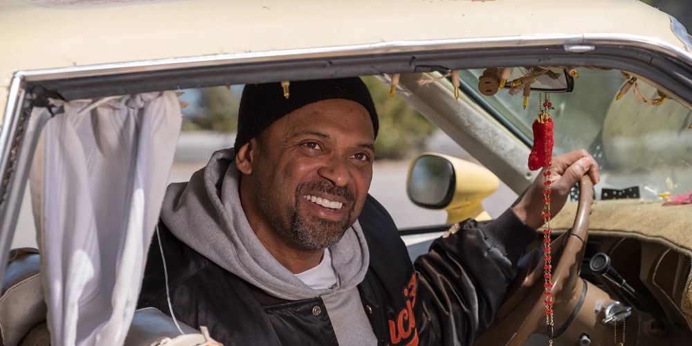 Bobby smiles through car window in The Last Black Man in San Francisco