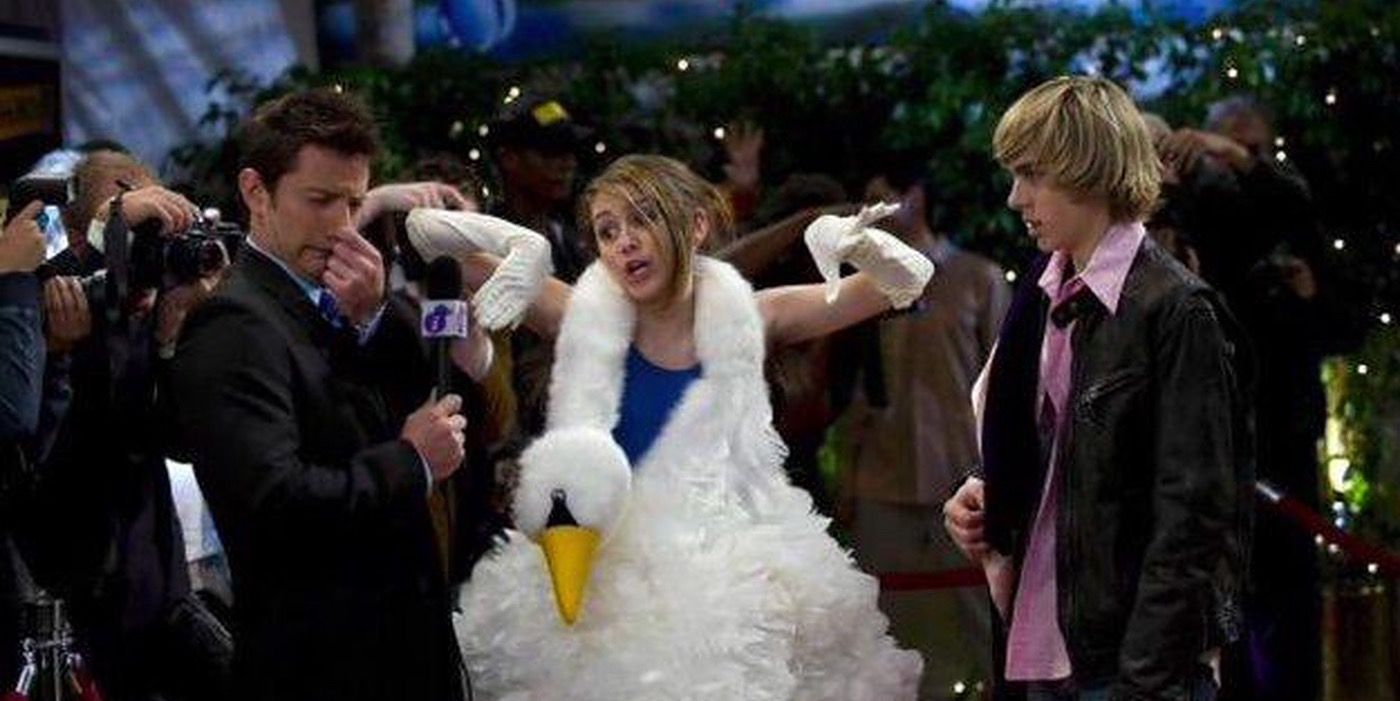 Miley wearing a big swan dress at premiere with Jake Ryan.