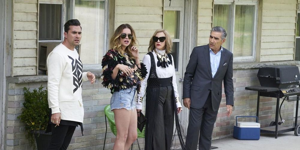The Rose family looks bewildered on porch in Schitt's Creek